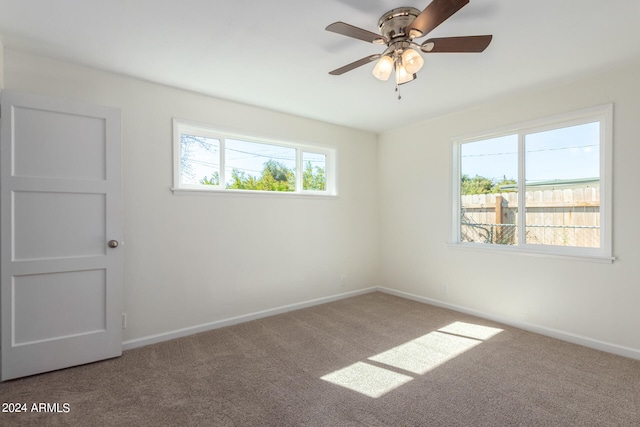 unfurnished room featuring ceiling fan and carpet