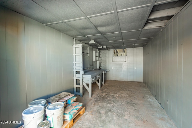 basement featuring wooden walls