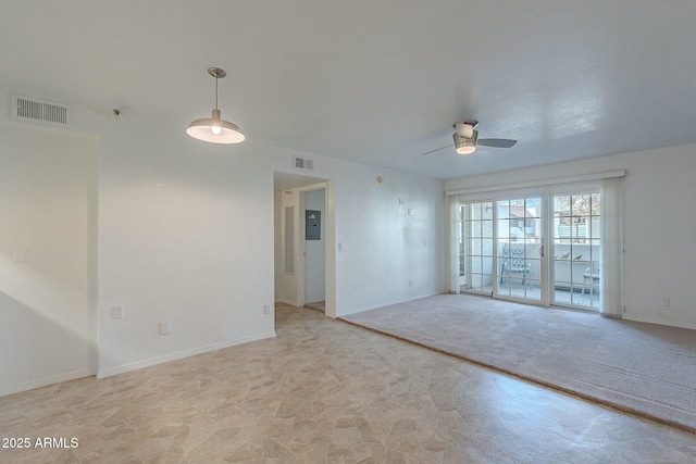 carpeted spare room with ceiling fan and electric panel