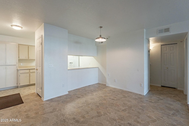 spare room featuring a textured ceiling