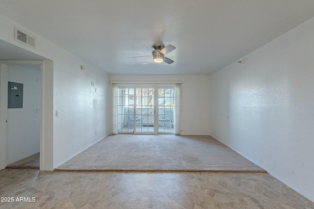 carpeted empty room featuring ceiling fan and electric panel