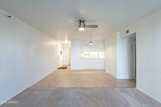 unfurnished room featuring ceiling fan and light colored carpet