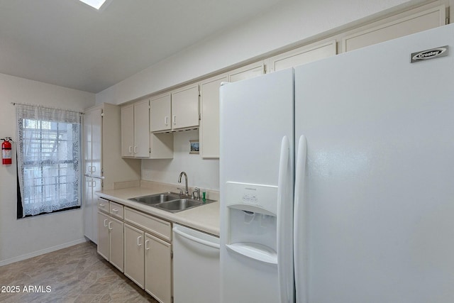 kitchen featuring white cabinets, sink, and white appliances