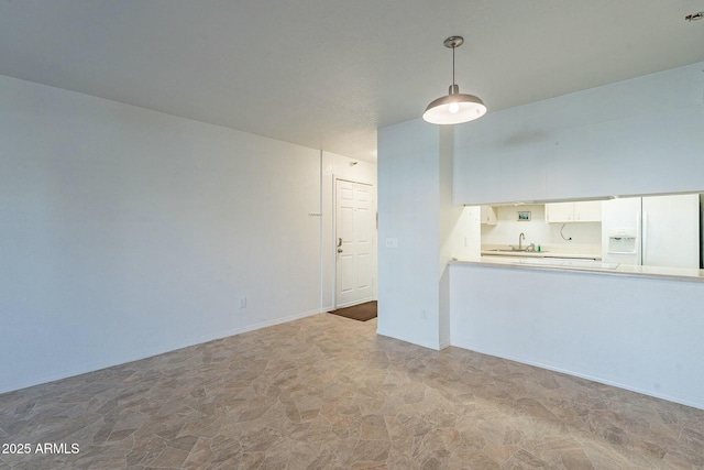 unfurnished living room featuring sink