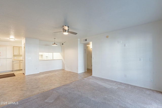 unfurnished room featuring ceiling fan and light carpet