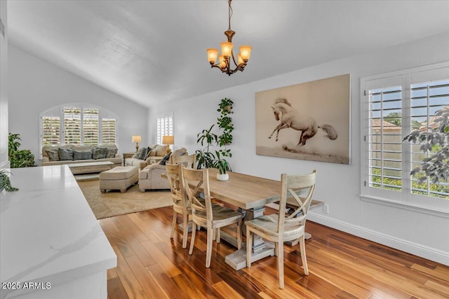 4402 E Barwick Dr, Cave Creek, AZ 85331 - dining space with a chandelier, wood finished floors, plenty of natural light, and vaulted ceiling