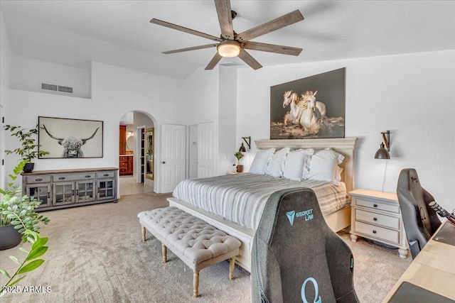 4402 E Barwick Dr, Cave Creek, AZ 85331 - carpeted bedroom with arched walkways, vaulted ceiling, ensuite bath, and ceiling fan