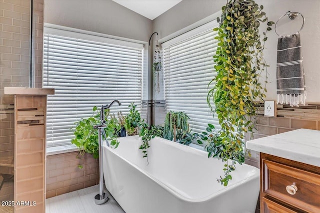 4402 E Barwick Dr, Cave Creek, AZ 85331 - bathroom with tile walls, a freestanding tub, plenty of natural light, and tile patterned floors