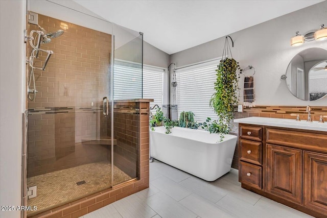 4402 E Barwick Dr, Cave Creek, AZ 85331 - bathroom featuring a shower stall, vanity, a soaking tub, vaulted ceiling, and tile patterned floors