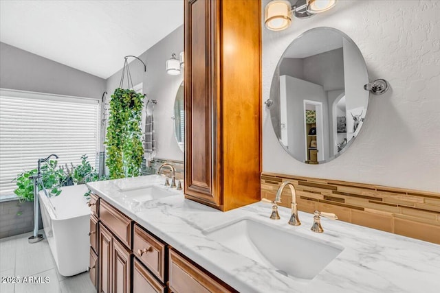 4402 E Barwick Dr, Cave Creek, AZ 85331 - full bathroom featuring a freestanding bath, double vanity, and vaulted ceiling