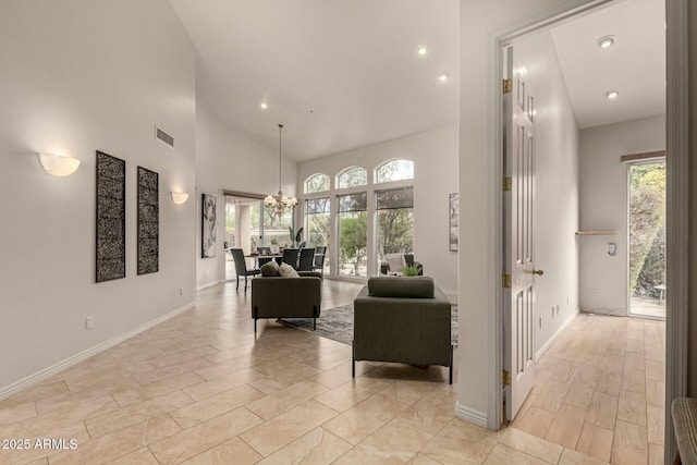 living room with a high ceiling and an inviting chandelier