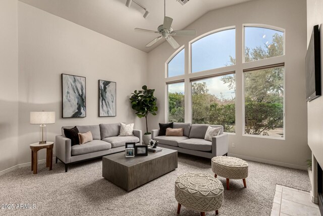 living room with ceiling fan, carpet floors, and lofted ceiling