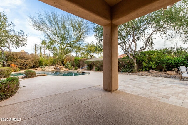 view of patio featuring a fenced in pool