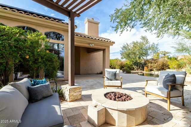 view of patio / terrace featuring an outdoor living space with a fire pit