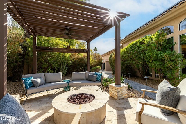 view of patio / terrace with a pergola, an outdoor living space with a fire pit, and ceiling fan