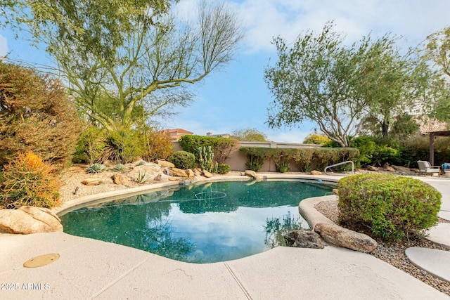 view of swimming pool featuring a diving board