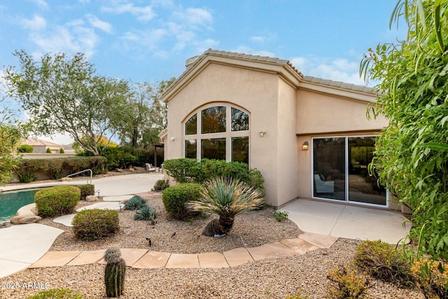 view of side of home featuring a patio area