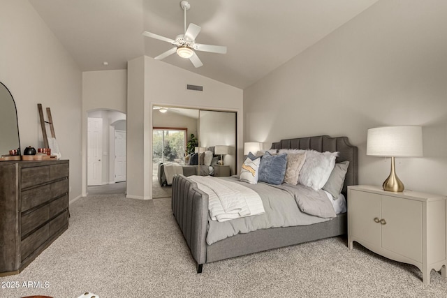 carpeted bedroom with ceiling fan, a closet, and lofted ceiling