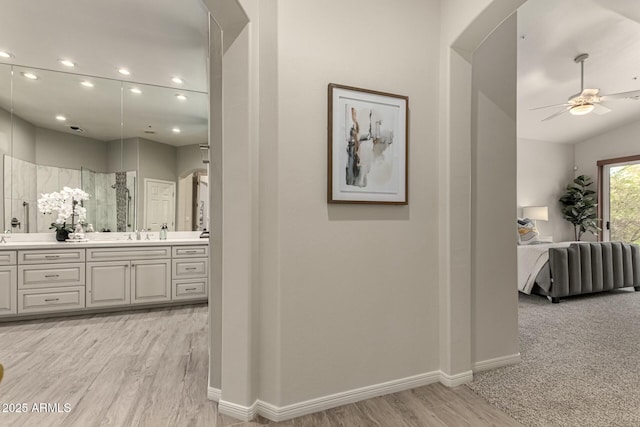 hall with light hardwood / wood-style floors and sink