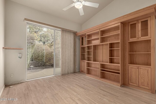 interior space featuring light hardwood / wood-style floors, vaulted ceiling, and ceiling fan