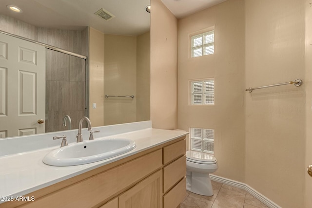 bathroom with toilet, vanity, tile patterned floors, and a shower with door