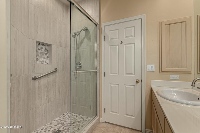 bathroom featuring tile patterned flooring, vanity, and a shower with shower door