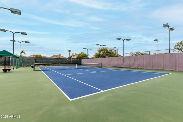 view of tennis court with basketball hoop