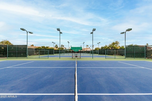 view of tennis court with basketball hoop