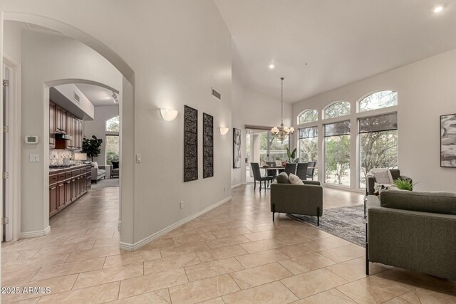 interior space with a high ceiling and a notable chandelier