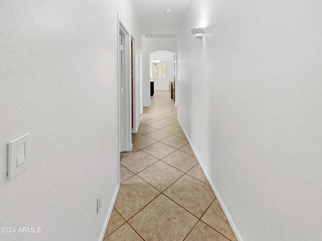 hall with light tile patterned floors