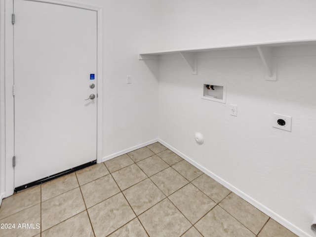 clothes washing area featuring hookup for an electric dryer, washer hookup, and light tile patterned floors