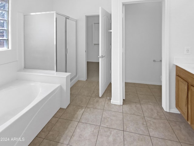 bathroom featuring vanity, tile patterned floors, and separate shower and tub