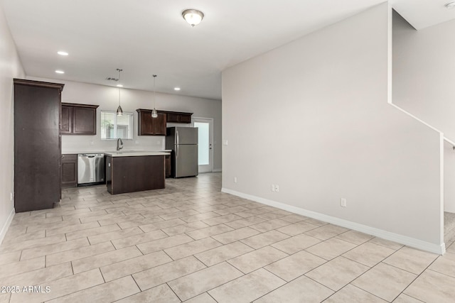 2000 N 36th St Unit 29, Phoenix, AZ 85008 - kitchen featuring appliances with stainless steel finishes, open floor plan, light countertops, dark brown cabinets, and recessed lighting
