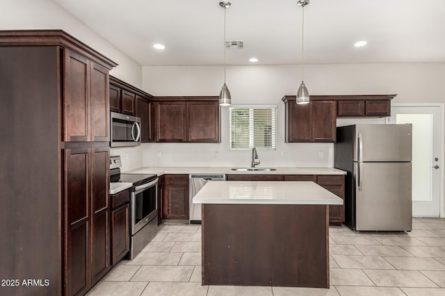 2000 N 36th St Unit 29, Phoenix, AZ 85008 - kitchen with stainless steel appliances, a sink, light tile patterned floors, dark brown cabinetry, and recessed lighting