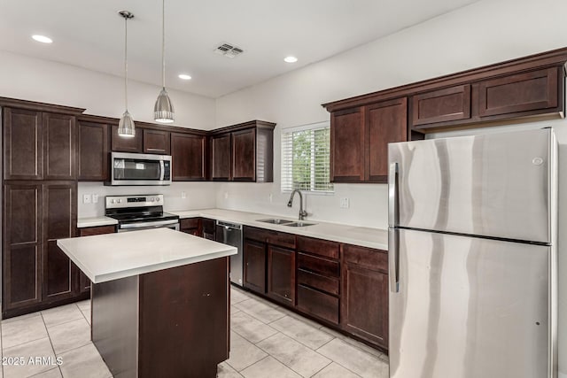 2000 N 36th St Unit 29, Phoenix, AZ 85008 - kitchen featuring stainless steel appliances, a sink, dark brown cabinets, light countertops, and a kitchen island