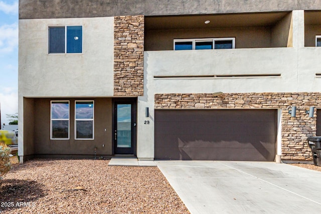 2000 N 36th St Unit 29, Phoenix, AZ 85008 - view of front of home with a garage, stucco siding, concrete driveway, and stone siding