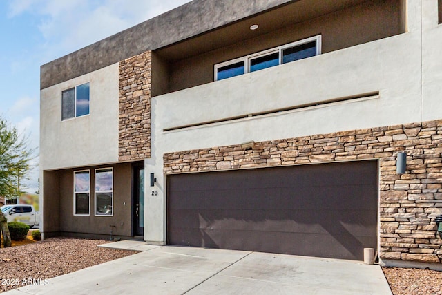 2000 N 36th St Unit 29, Phoenix, AZ 85008 - view of front facade featuring stone siding, stucco siding, a garage, and driveway