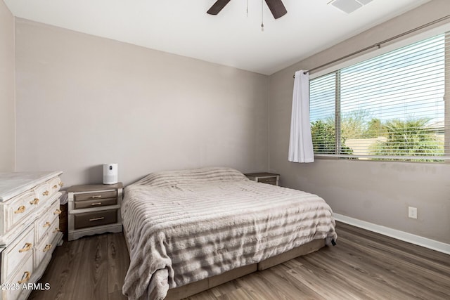 19920 W Monterosa St, Litchfield Park, AZ 85340 - bedroom with dark wood-style floors, ceiling fan, visible vents, and baseboards