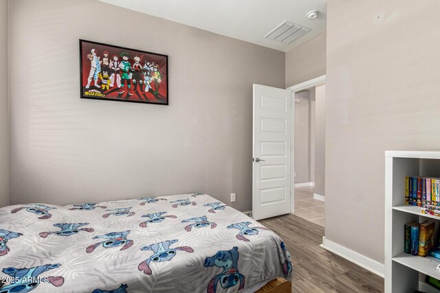 19920 W Monterosa St, Litchfield Park, AZ 85340 - bedroom with wood finished floors, visible vents, and baseboards