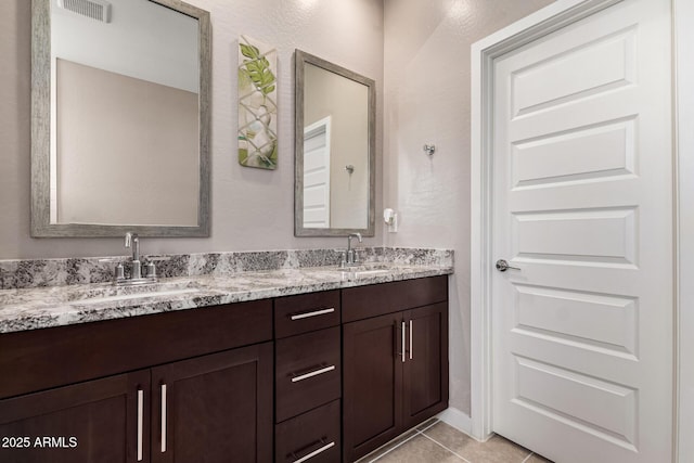 19920 W Monterosa St, Litchfield Park, AZ 85340 - bathroom featuring double vanity, tile patterned flooring, visible vents, and a sink