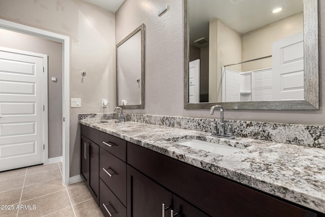 19920 W Monterosa St, Litchfield Park, AZ 85340 - bathroom featuring double vanity, tile patterned flooring, a sink, and baseboards