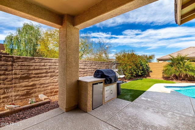 19920 W Monterosa St, Litchfield Park, AZ 85340 - view of patio featuring grilling area, an outdoor kitchen, a fenced backyard, and a fenced in pool