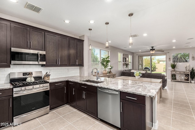 19920 W Monterosa St, Litchfield Park, AZ 85340 - kitchen with appliances with stainless steel finishes, open floor plan, visible vents, and a peninsula