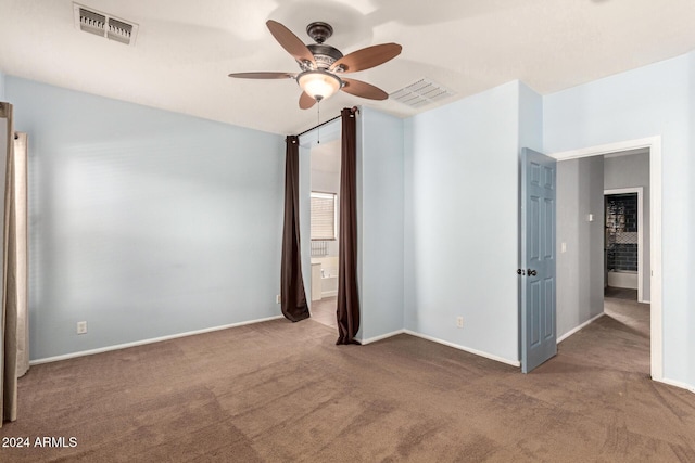 carpeted spare room with ceiling fan