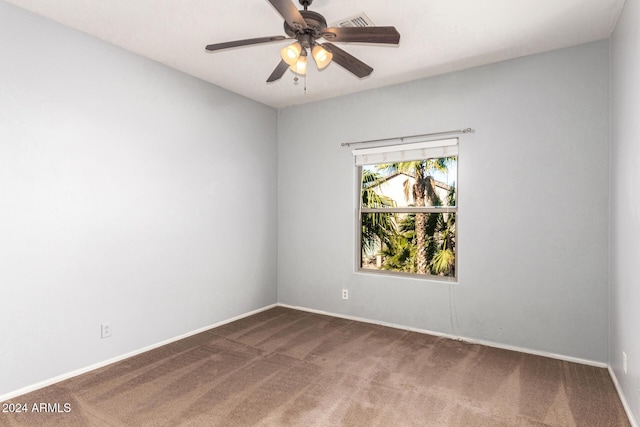 carpeted spare room with ceiling fan