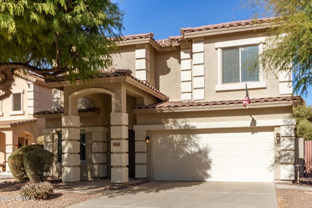 mediterranean / spanish-style home with a garage