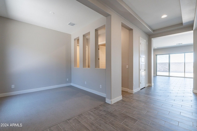 unfurnished room with a healthy amount of sunlight and carpet floors