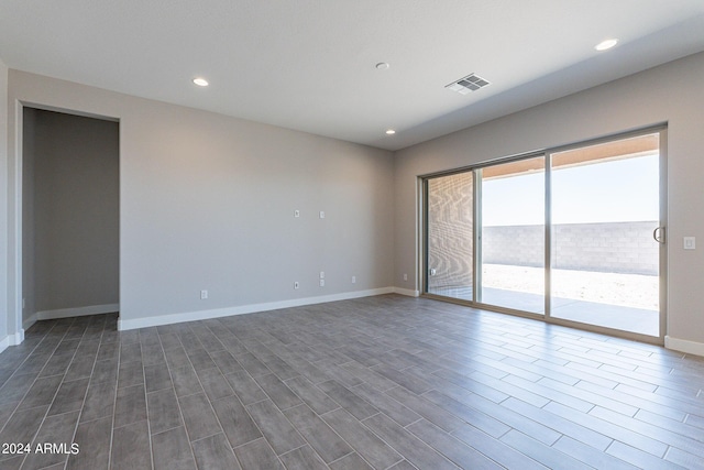 spare room with hardwood / wood-style floors