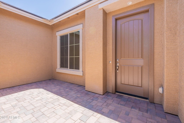 entrance to property featuring a patio