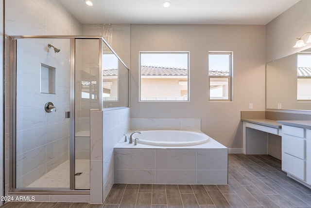 bathroom featuring vanity and plus walk in shower